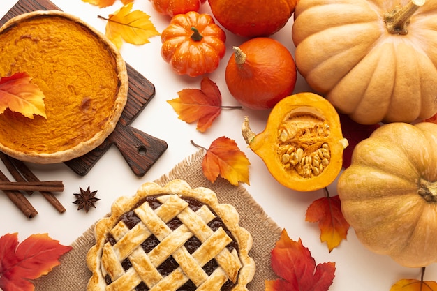 Flat lay assortment with pumpkins and pie