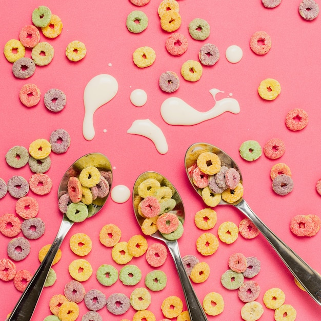 Flat lay assortment with spoons and colourful cereals 