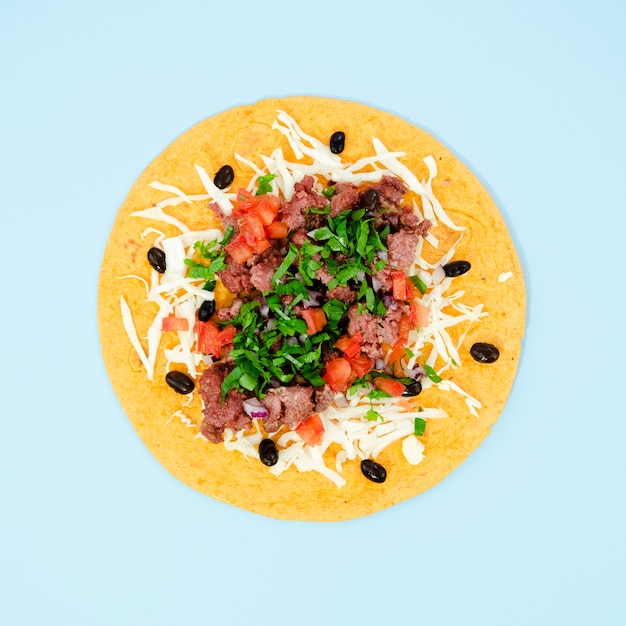 Flat lay assortment with tasty mexican food on blue background