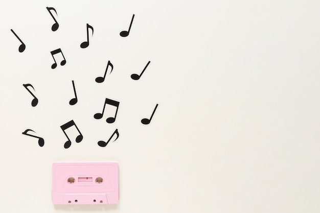 Free photo flat lay audio cassette with musical notes