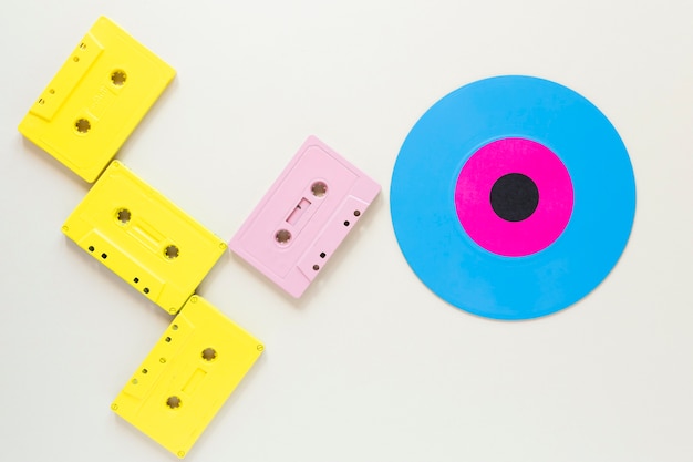 Flat lay audio cassettes with a vinyl disc