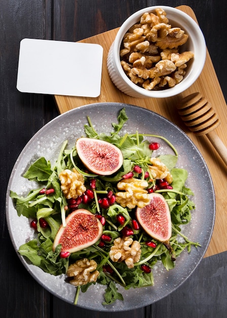 Flat lay of autumn fig salad on plate with walnuts