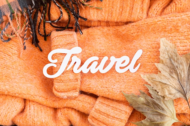 Free photo flat lay autumn traveling elements assortment with travel lettering