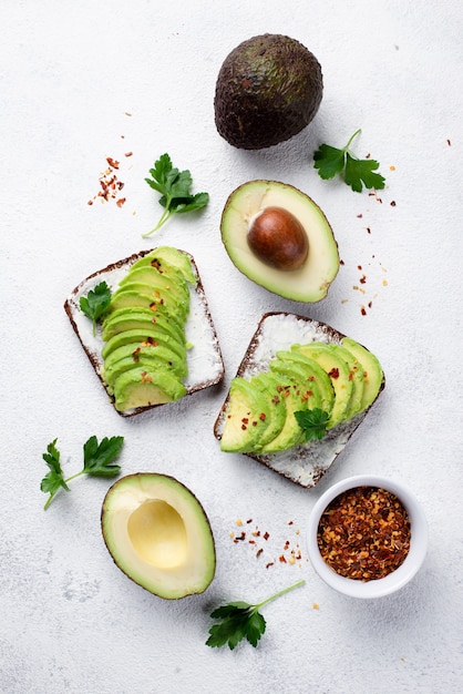 Flat lay of avocado toast for breakfast with herbs and spices