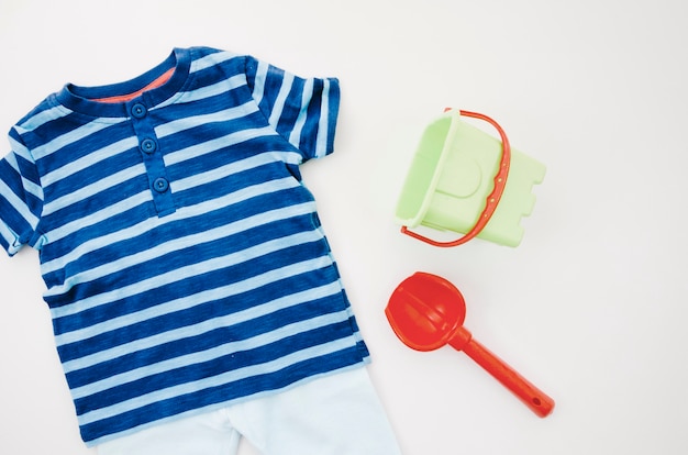 Flat lay baby clothes with toys