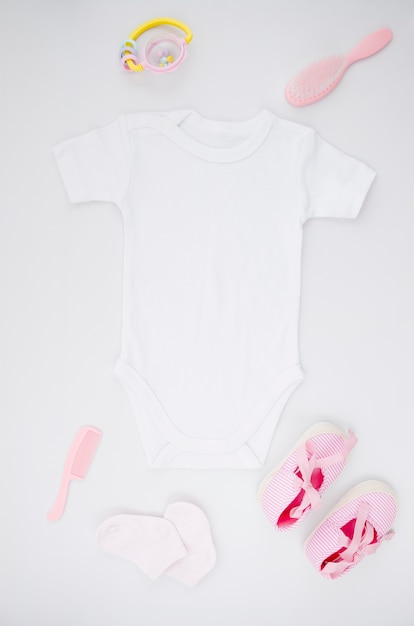 Flat lay baby clothes with white background