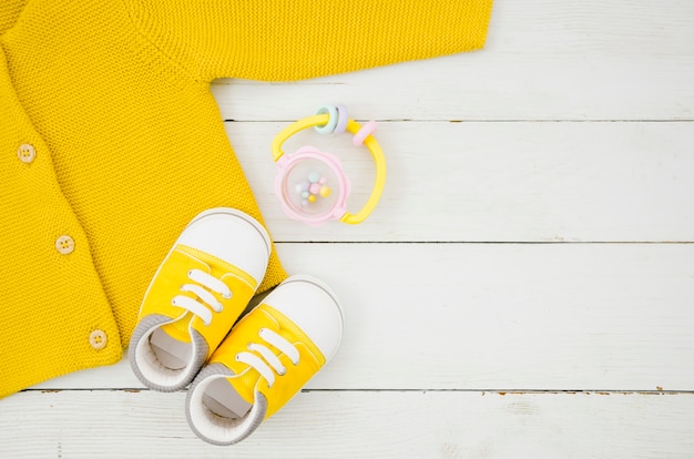 Flat lay baby clothes with wooden background