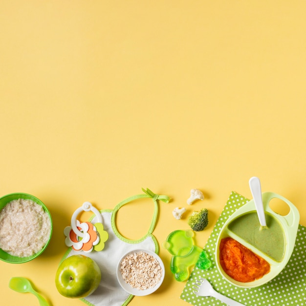 Flat lay baby food on yellow background