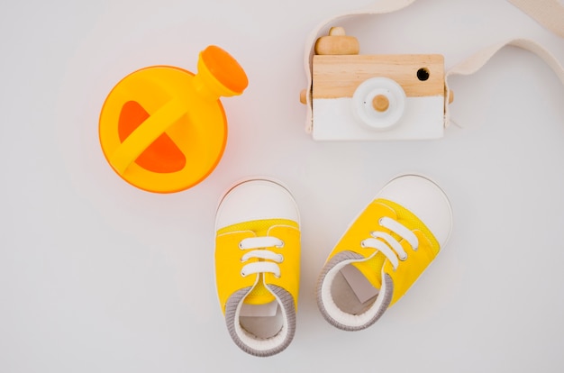 Free photo flat lay baby shoes with white background