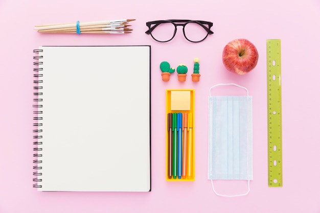 Free photo flat lay of back to school materials with notebook and pencils