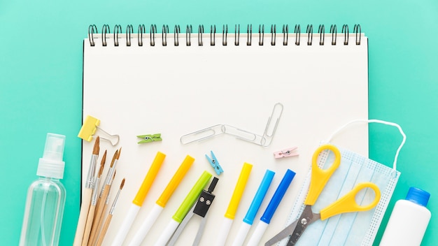 Flat lay of back to school supplies with notebook and pencils