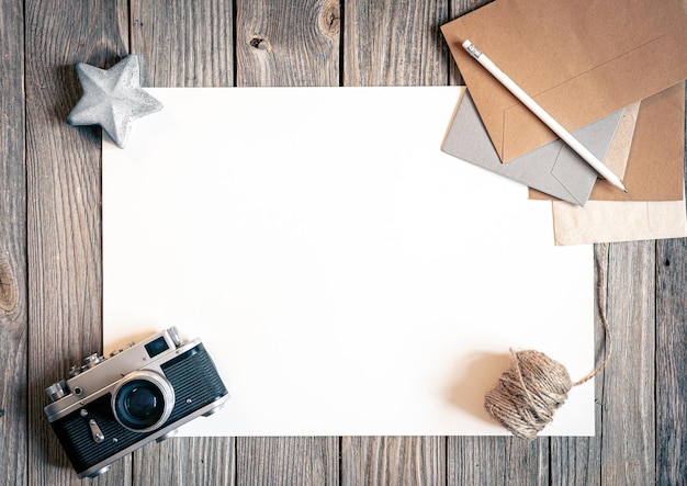 Flat lay background with retro camera and letters on wooden surface