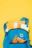 Free photo flat lay backpack with school supplies