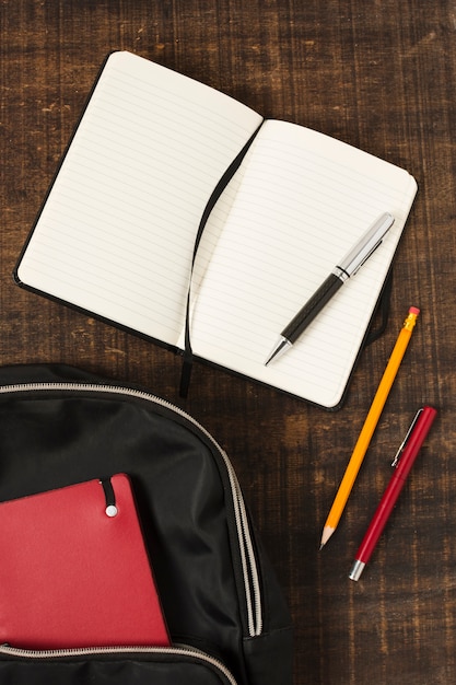 Free photo flat lay of backpack with stationery accessories