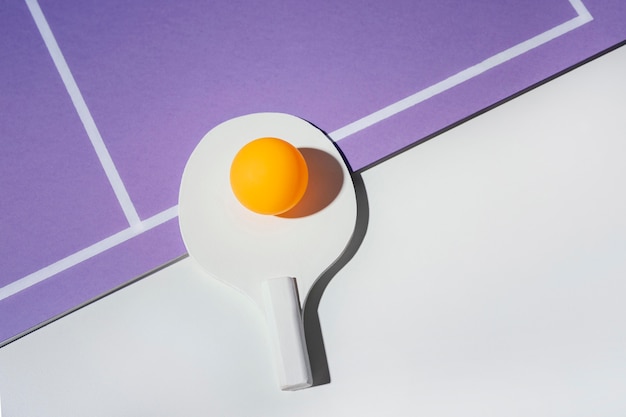 Flat lay ball on ping pong paddle