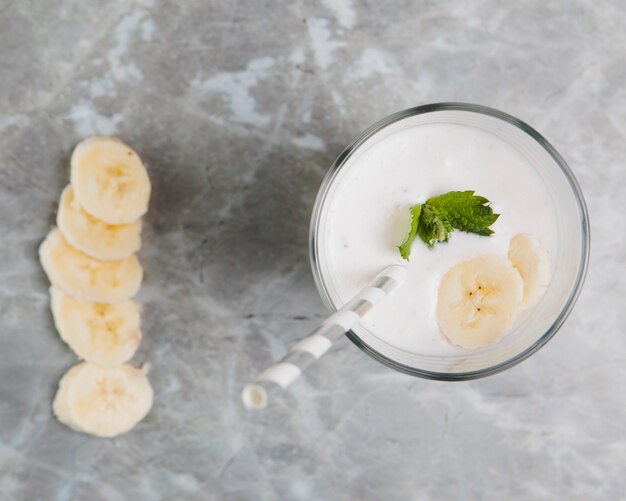 Flat lay of banana slices on marble background