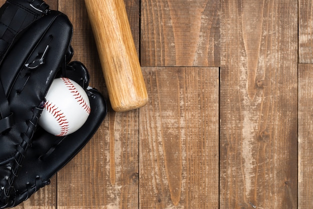 Flat lay of baseball bat with glove