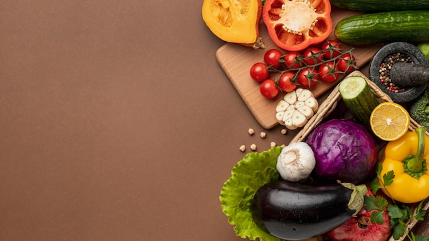 Flat lay of basket of organic vegetables with copy space