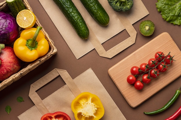 Flat lay of basket of organic vegetables with grocery bag