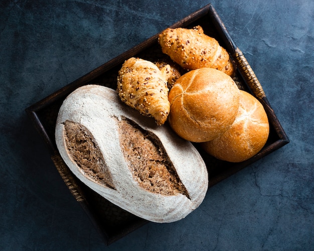 Flat lay of a basket with bread and croissants