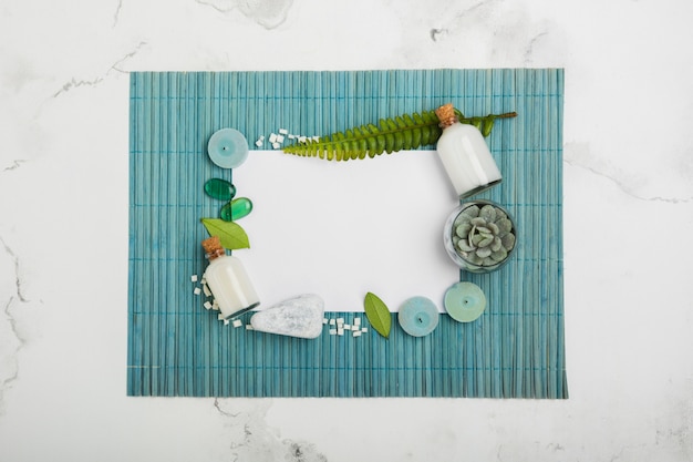 Flat lay bath products on blue mat with white rectangle