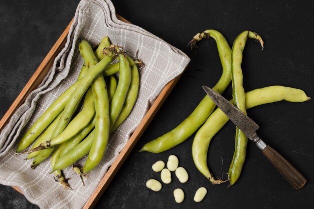 Flat lay of beans in basket with garlic