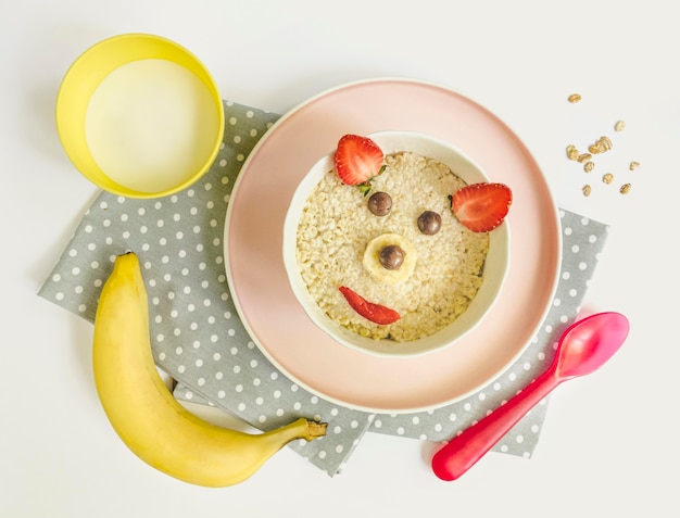 Free photo flat lay bear shape cereals and glass of milk