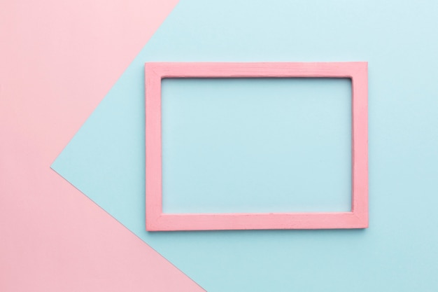 Flat lay of beautiful pink wooden frame concept