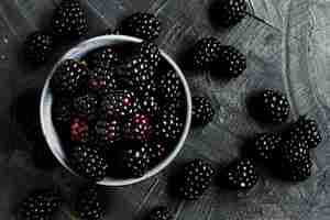 Free photo flat lay black forest fruits in bowl