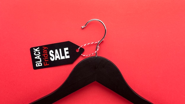 Flat lay black friday assortment on red background with copy space