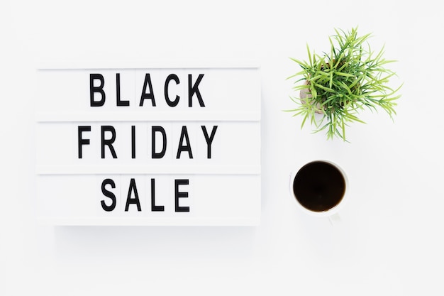 Free photo flat lay black friday light box with plant