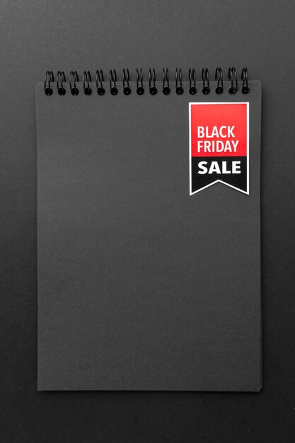 Flat lay black friday notepad on black background