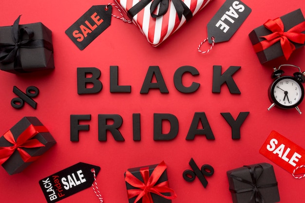 Flat lay black friday sales arrangement on red background