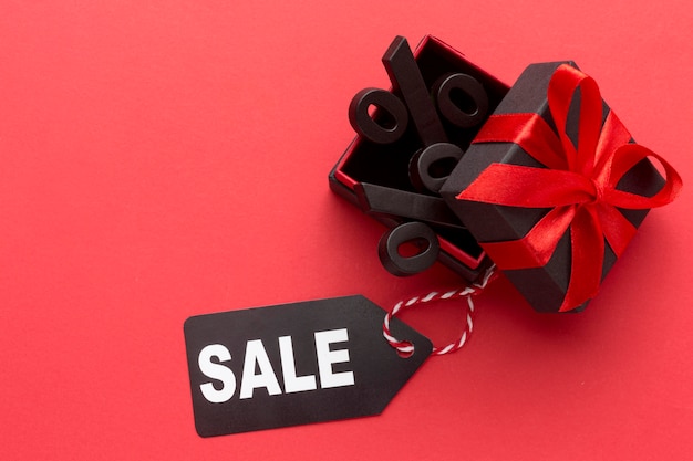 Free photo flat lay black friday sales composition on red background