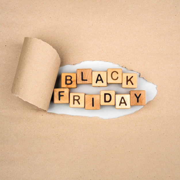 Free photo flat lay of black friday word on craft paper