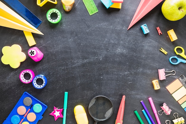 Flat lay of blackboard and school tools