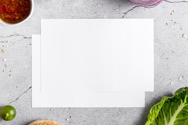 Free photo flat lay of blank menu paper on concrete with vegetables