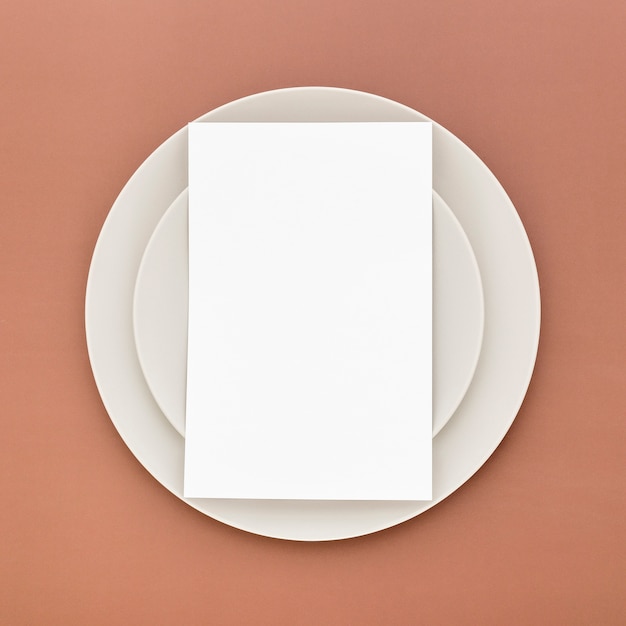Flat lay of blank menu paper on plates