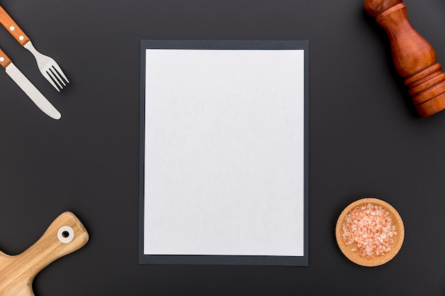 Flat lay of blank menu paper with knife and fork