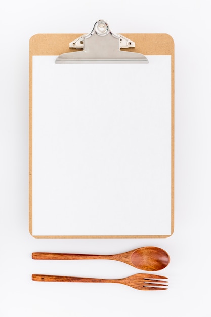 Free photo flat lay of blank menu with wooden cutlery