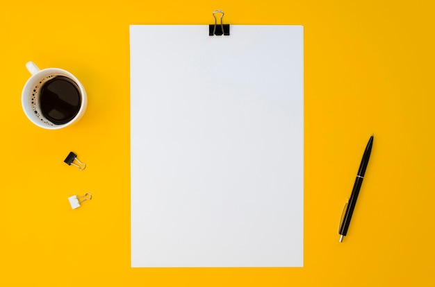 flat lay of blank paper with coffee mug