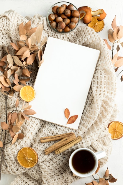 Flat lay of blank placard with autumn leaves and cinnamon sticks