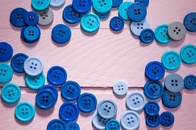 Flat lay of blue buttons with copy space