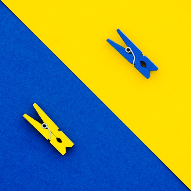 Flat-lay blue and yellow clothes pins