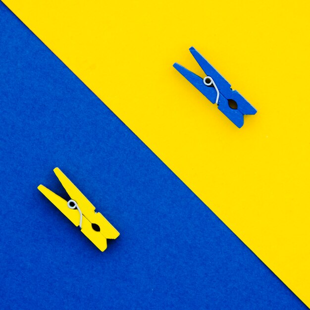 Flat-lay blue and yellow clothes pins