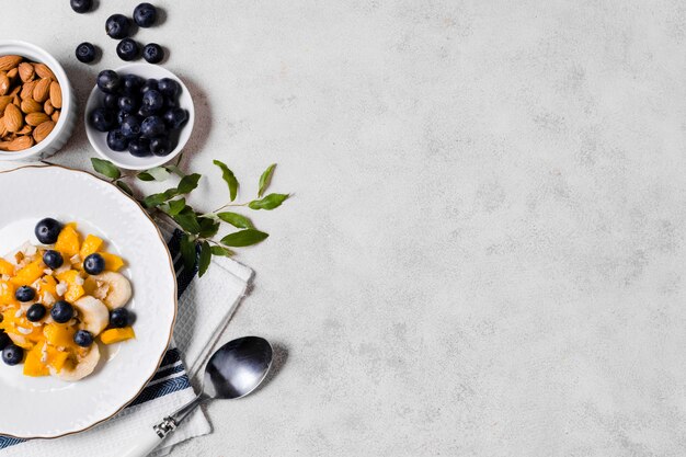 Flat lay of blueberries and mango with copy space