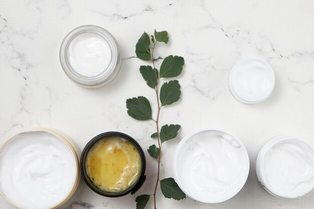 Flat lay body cream arrangement on marble background