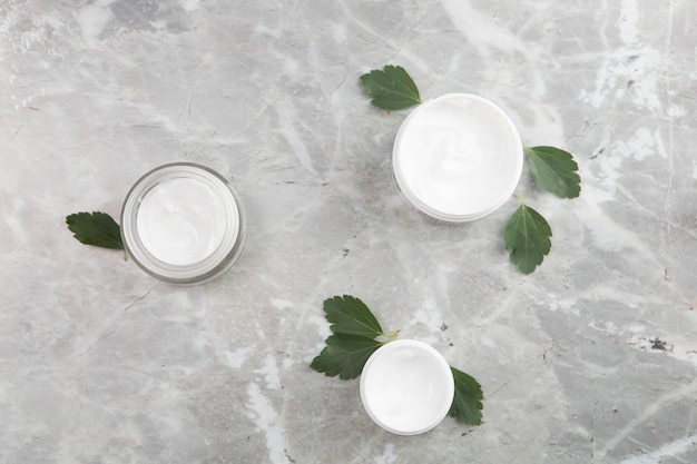 Flat lay body cream products on marble background