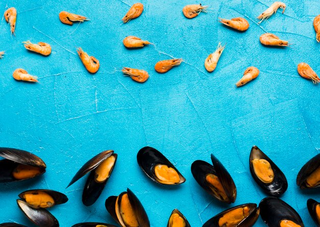 Flat-lay boiled mussels scattered on tabletop