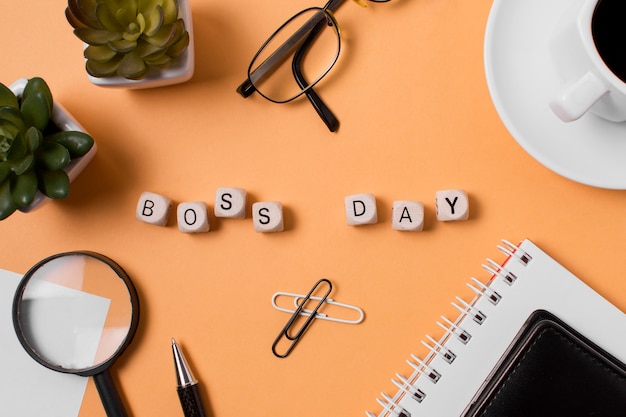 Free photo flat lay boss's day arrangement on orange background